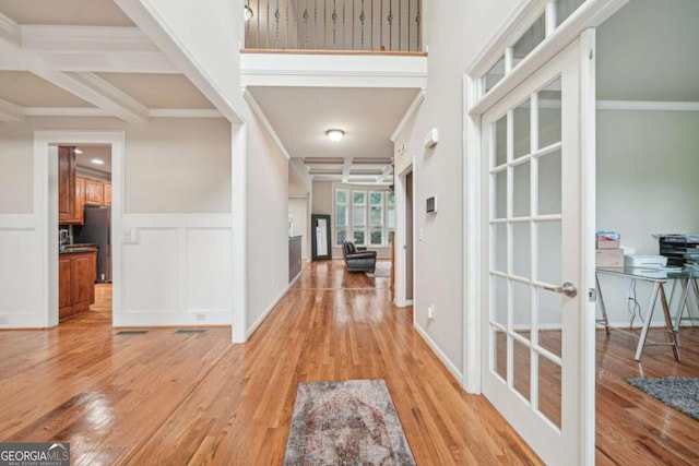 1979 Alcovy Shoals Blf, Lawrenceville, GA 30045 - foyer featuring light wood-style floors, french doors, coffered ceiling, wainscoting, and crown molding