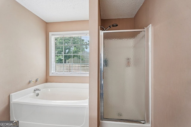 1415 Langdon Park Ct, Winder, GA 30680 - full bathroom with a shower stall, a garden tub, and a textured ceiling