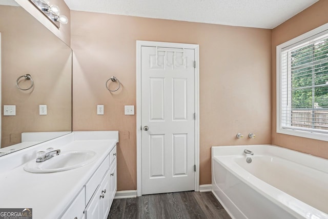 1415 Langdon Park Ct, Winder, GA 30680 - bathroom featuring vanity, a garden tub, and wood finished floors