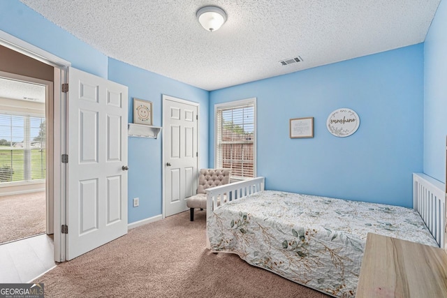 1415 Langdon Park Ct, Winder, GA 30680 - carpeted bedroom featuring a textured ceiling