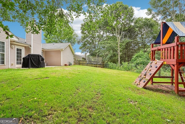 1415 Langdon Park Ct, Winder, GA 30680 - fenced backyard with a trampoline and a playground