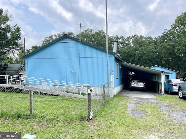 36 Ocean View St, Woodbine, GA 31569 - view of home's exterior with an attached carport and driveway