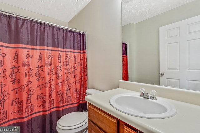 12303 Waldrop Pl, Decatur, GA 30034 - full bathroom featuring a textured ceiling, vanity, toilet, and curtained shower