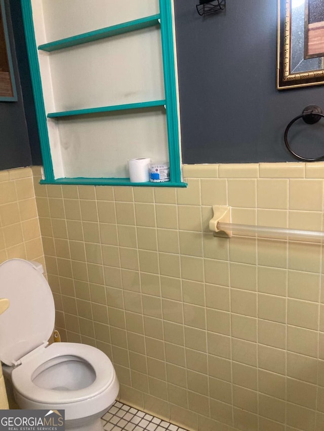 2722 Alden St, Macon, GA 31206 - half bathroom featuring tile walls, toilet, wainscoting, and tile patterned floors