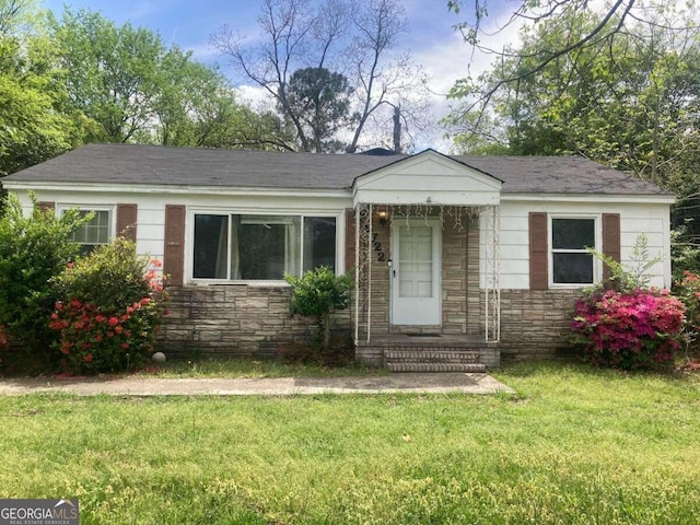2722 Alden St, Macon, GA 31206 - view of front of home with stone siding, a front yard, and a shingled roof