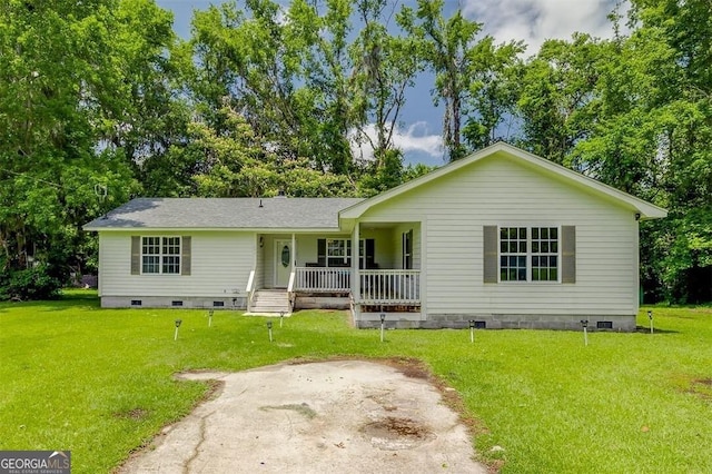 907 Magnolia Ext, Guyton, GA 31312 - view of front of house with crawl space, a porch, a front yard, and view of scattered trees