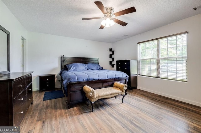 907 Magnolia Ext, Guyton, GA 31312 - bedroom featuring wood finished floors, a textured ceiling, baseboards, and ceiling fan