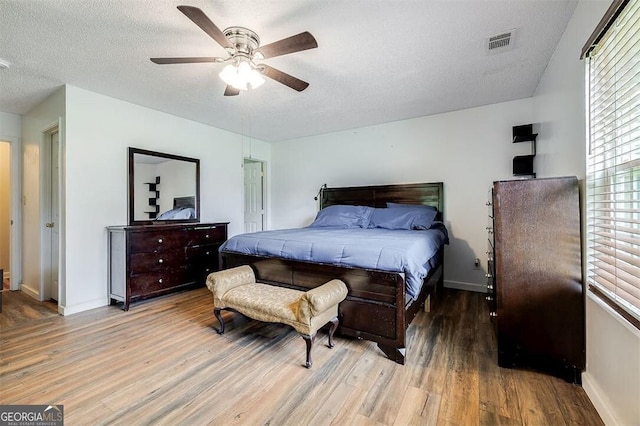 907 Magnolia Ext, Guyton, GA 31312 - bedroom with light wood-style flooring, baseboards, a textured ceiling, and ceiling fan