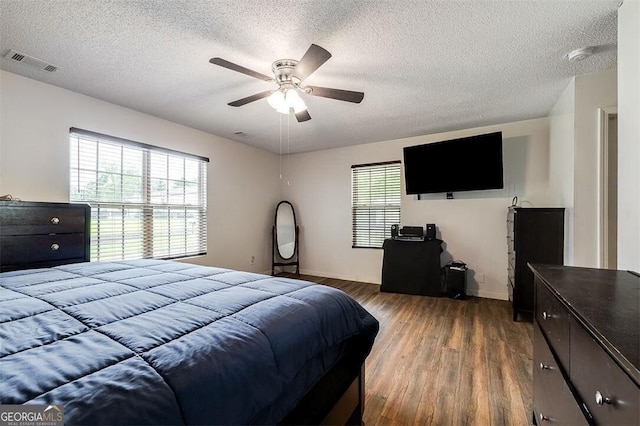 907 Magnolia Ext, Guyton, GA 31312 - bedroom featuring wood finished floors, a textured ceiling, baseboards, and a ceiling fan