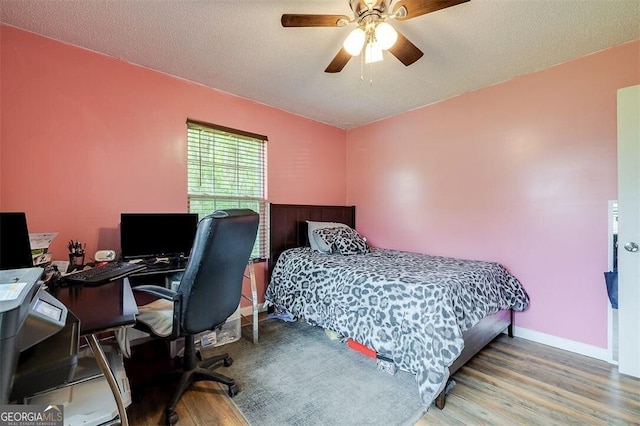 907 Magnolia Ext, Guyton, GA 31312 - bedroom featuring wood finished floors, a desk, a ceiling fan, and baseboards