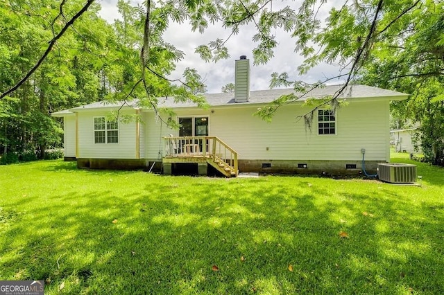 907 Magnolia Ext, Guyton, GA 31312 - rear view of house featuring a chimney, a lawn, a wooden deck, and cooling unit