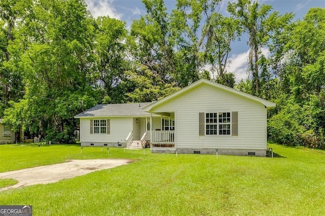 907 Magnolia Ext, Guyton, GA 31312 - view of front of property featuring crawl space, a front yard, covered porch, and view of scattered trees