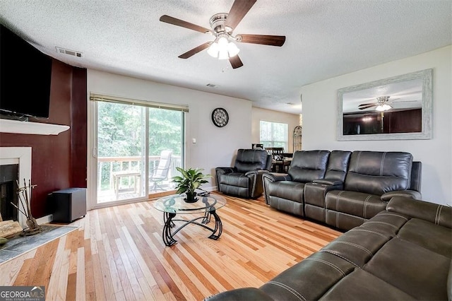 907 Magnolia Ext, Guyton, GA 31312 - living room featuring ceiling fan, light wood finished floors, a textured ceiling, and baseboards