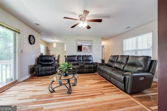 907 Magnolia Ext, Guyton, GA 31312 - living area featuring light wood finished floors, ceiling fan, a textured ceiling, and baseboards