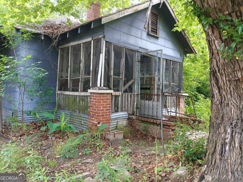 906 Winston Rd, Columbus, GA 31903 - rear view of house with a sunroom and a chimney