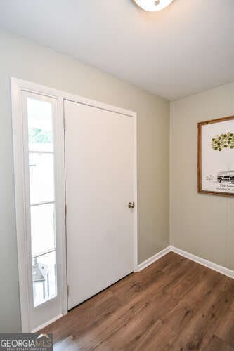 120 Chambers Ave, Cornelia, GA 30531 - spare room with healthy amount of natural light, wood finished floors, and baseboards