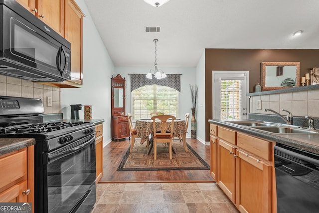 507 Hunterian Pl, Newnan, GA 30265 - kitchen with black appliances, a sink, a chandelier, dark countertops, and decorative backsplash