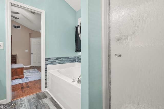 507 Hunterian Pl, Newnan, GA 30265 - full bath featuring wood finished floors, vaulted ceiling, and a bath