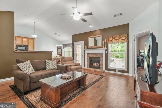 507 Hunterian Pl, Newnan, GA 30265 - living area with a ceiling fan, wood finished floors, lofted ceiling, baseboards, and a stone fireplace