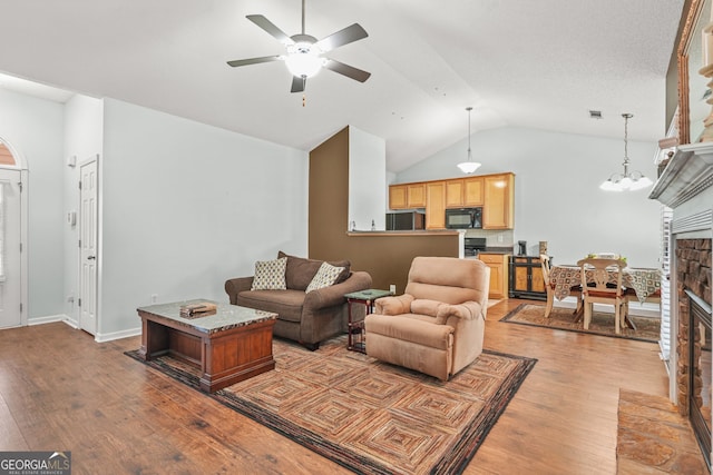 507 Hunterian Pl, Newnan, GA 30265 - living room featuring wood finished floors, ceiling fan, lofted ceiling, and a fireplace