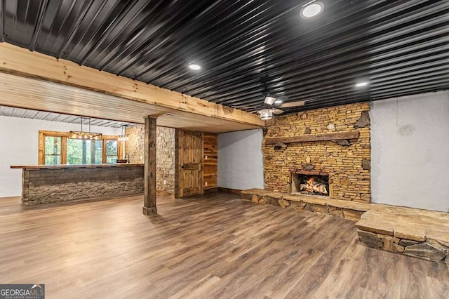 11 Collins Hollow Cv, Morganton, GA 30560 - unfurnished living room featuring a stone fireplace and wood finished floors