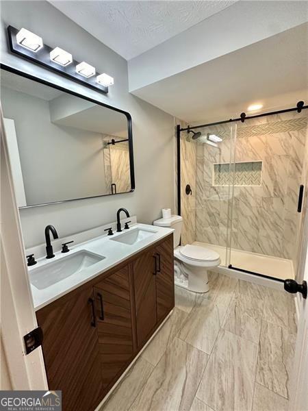 5419 Lake Dr, Douglasville, GA 30135 - full bath with toilet, a stall shower, and double vanity