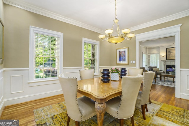 1821 N Rock Springs Rd NE, Atlanta, GA 30324 - dining area featuring a chandelier, crown molding, wainscoting, wood finished floors, and a fireplace