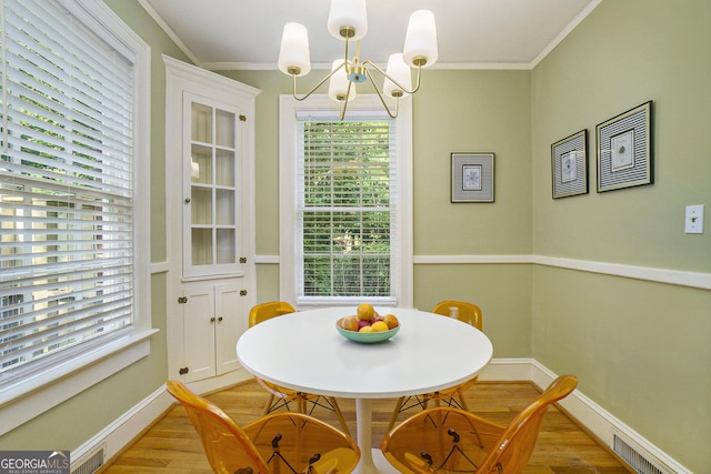 1821 N Rock Springs Rd NE, Atlanta, GA 30324 - dining area with wood finished floors, crown molding, a chandelier, and healthy amount of natural light