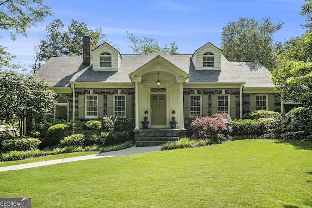 1821 N Rock Springs Rd NE, Atlanta, GA 30324 - cape cod home with brick siding, roof with shingles, and a front lawn