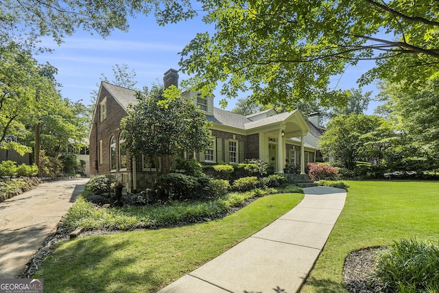 1821 N Rock Springs Rd NE, Atlanta, GA 30324 - view of front facade featuring brick siding, a front lawn, and a chimney