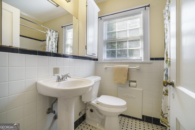 1821 N Rock Springs Rd NE, Atlanta, GA 30324 - bathroom featuring ornamental molding, tile walls, plenty of natural light, tile patterned floors, and a wainscoted wall