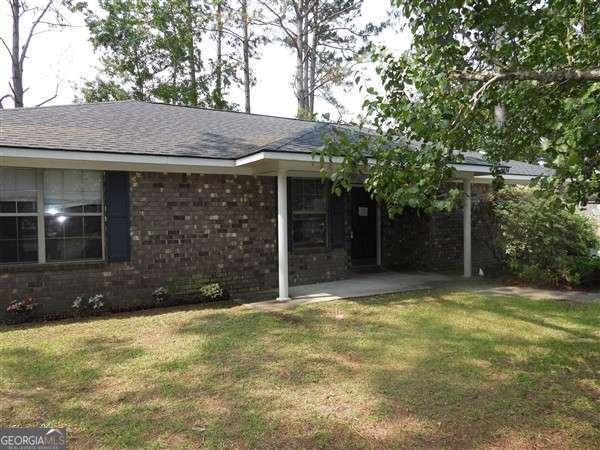2324 Suttle Ct, Hinesville, GA 31313 - view of home's exterior with a lawn, brick siding, and a shingled roof