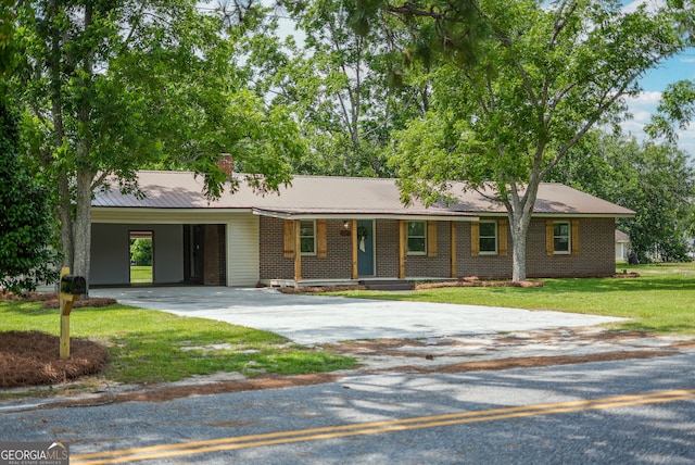 4124 W Rd, Blackshear, GA 31516 - single story home with concrete driveway, covered porch, a chimney, a front yard, and an attached carport