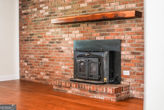 4124 W Rd, Blackshear, GA 31516 - detailed view of wood finished floors, baseboards, and a wood stove