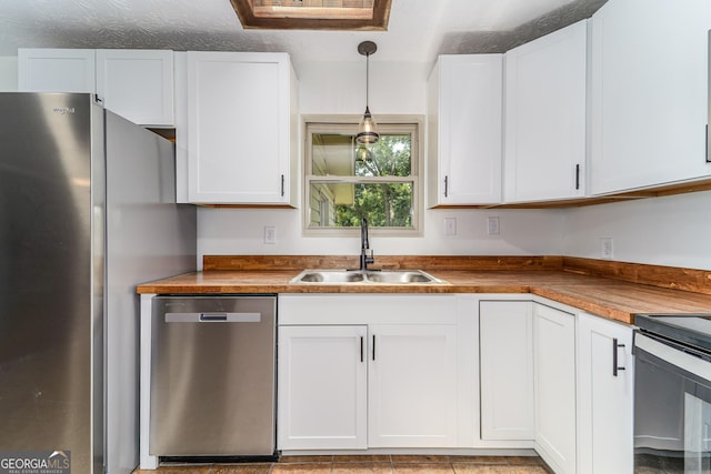 4124 W Rd, Blackshear, GA 31516 - kitchen with stainless steel appliances, a sink, white cabinetry, and decorative light fixtures