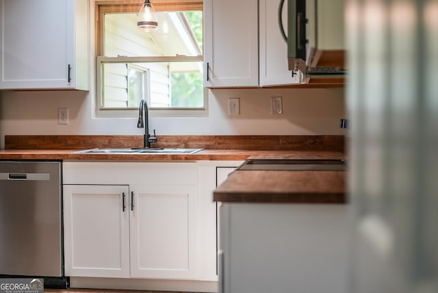 4124 W Rd, Blackshear, GA 31516 - kitchen featuring dishwasher, a sink, white cabinets, freestanding refrigerator, and wood counters