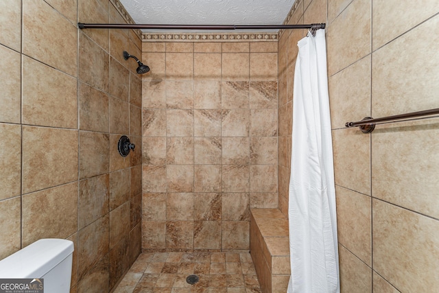 4124 W Rd, Blackshear, GA 31516 - bathroom with tiled shower, a textured ceiling, and toilet