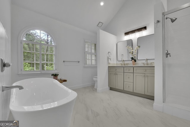305 River Glen Dr, Roswell, GA 30075 - bathroom with vaulted ceiling, double vanity, a soaking tub, marble look tiles, and tiled shower