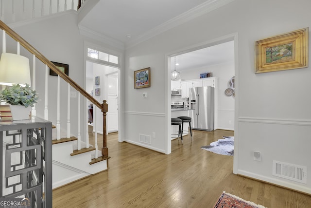 305 River Glen Dr, Roswell, GA 30075 - entrance foyer with crown molding, stairs, light wood-style floors, and baseboards