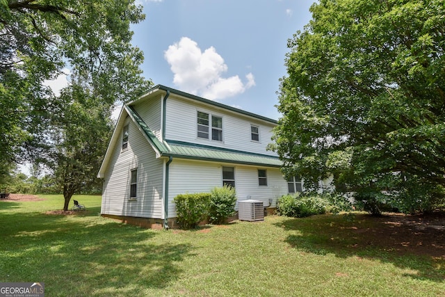 2048 Swint Rd, Griffin, GA 30224 - rear view of property featuring central air condition unit, a yard, and metal roof