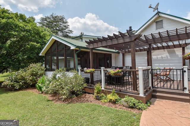 2048 Swint Rd, Griffin, GA 30224 - rear view of house with a pergola, a lawn, a wooden deck, and a sunroom