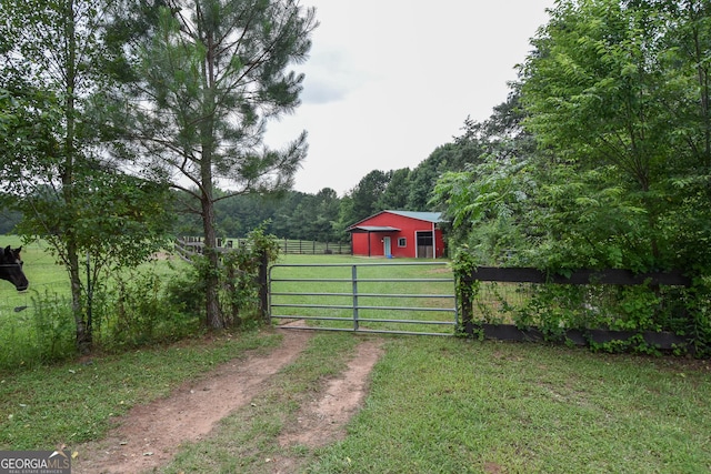 2048 Swint Rd, Griffin, GA 30224 - view of yard with driveway, a gate, and a pole building