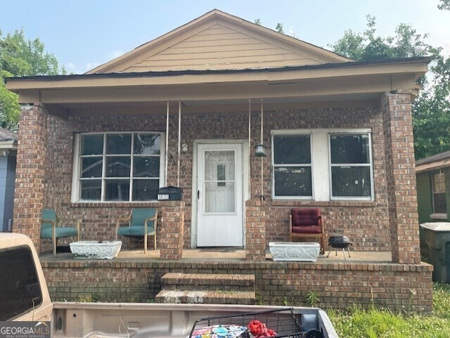 1025 Cope St, Savannah, GA 31415 - view of front of house with brick siding and covered porch