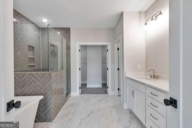 206 Grady Burrell Dr, Holly Springs, GA 30115 - full bath featuring a shower stall, vanity, marble look tile flooring, a walk in closet, and baseboards