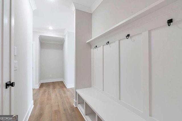 206 Grady Burrell Dr, Holly Springs, GA 30115 - mudroom with light wood-style floors, crown molding, and baseboards