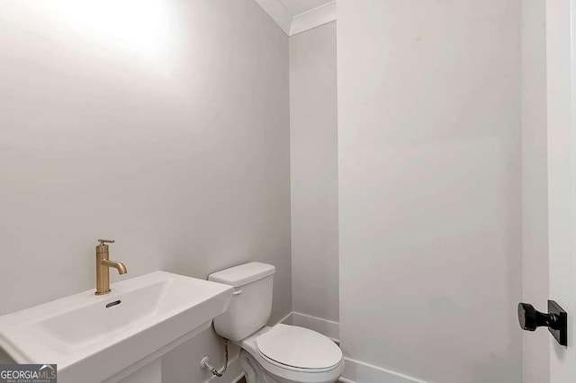 206 Grady Burrell Dr, Holly Springs, GA 30115 - bathroom with toilet, a sink, and baseboards