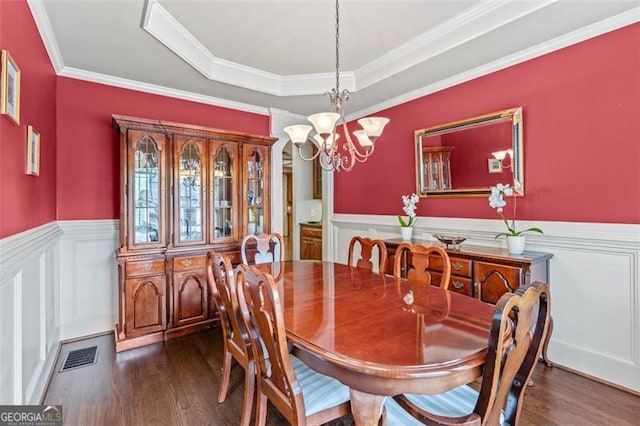 9065 Yellow Pine Ct, Gainesville, GA 30506 - dining area featuring dark wood-style flooring, wainscoting, a chandelier, a decorative wall, and a raised ceiling