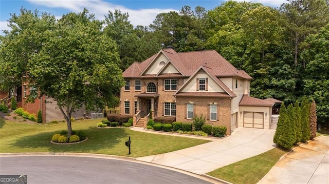 9065 Yellow Pine Ct, Gainesville, GA 30506 - colonial home featuring concrete driveway, brick siding, a front yard, and an attached garage