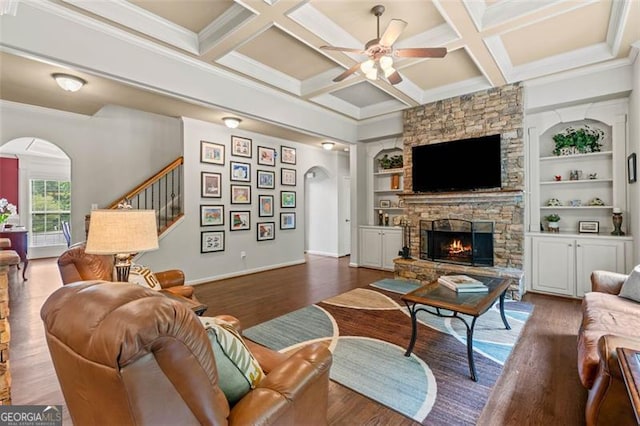 9065 Yellow Pine Ct, Gainesville, GA 30506 - living area with arched walkways, ceiling fan, wood finished floors, a stone fireplace, and crown molding
