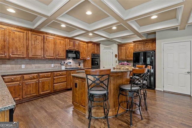 9065 Yellow Pine Ct, Gainesville, GA 30506 - kitchen featuring black appliances, brown cabinetry, a kitchen island, dark wood finished floors, and a breakfast bar area